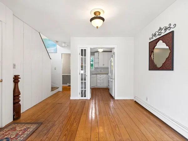 a view of a room with wooden floor and cabinet