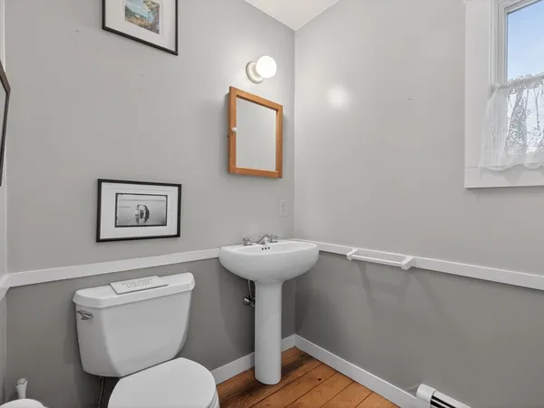 a bathroom with a toilet a sink and a mirror