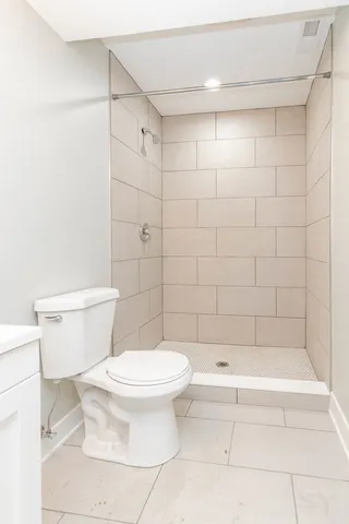 a view of a big room with wooden floor and windows