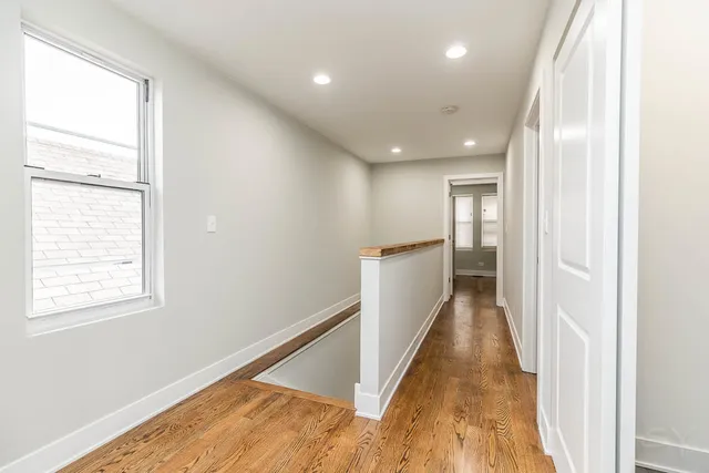 a view of a balcony with wooden floor and cabinet
