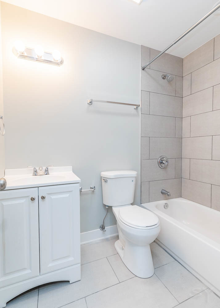 2109 West 18th Place Chicago, IL 60608 - Photo 24 of 63 a white toilet sitting next to a bathroom sink