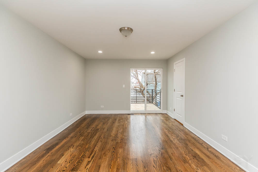 2109 West 18th Place Chicago, IL 60608 - Photo 27 of 63 a view of an empty room with wooden floor and a window