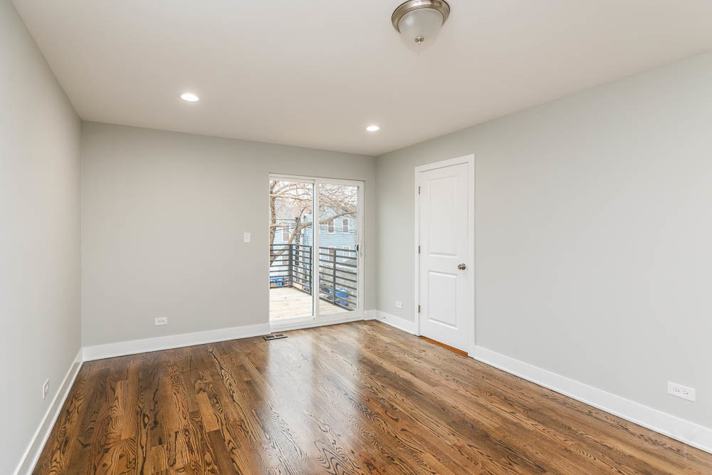 2109 West 18th Place Chicago, IL 60608 - Photo 28 of 63 a view of an empty room with wooden floor and a window