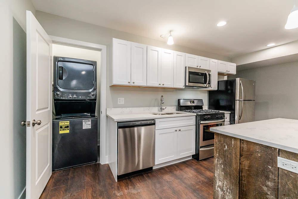 2109 West 18th Place Chicago, IL 60608 - Photo 43 of 63 a kitchen with a sink a microwave a refrigerator and cabinets