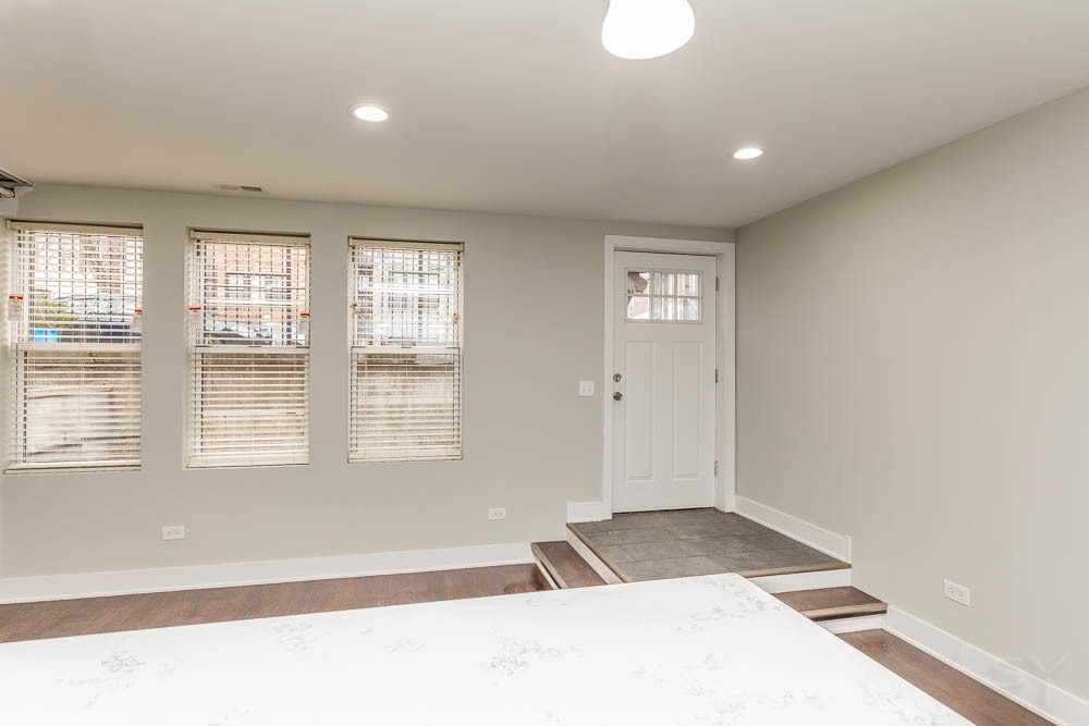 2109 West 18th Place Chicago, IL 60608 - Photo 50 of 63 a view of an empty room with wooden floor and a window
