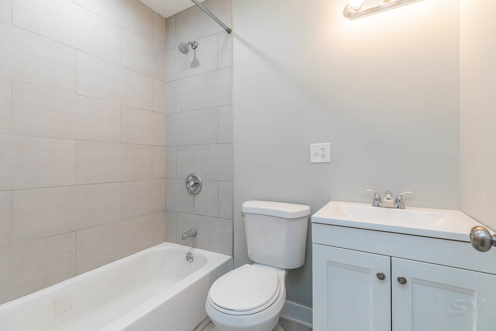 2109 West 18th Place Chicago, IL 60608 - Photo 52 of 63 a bathroom with a sink a toilet and shower