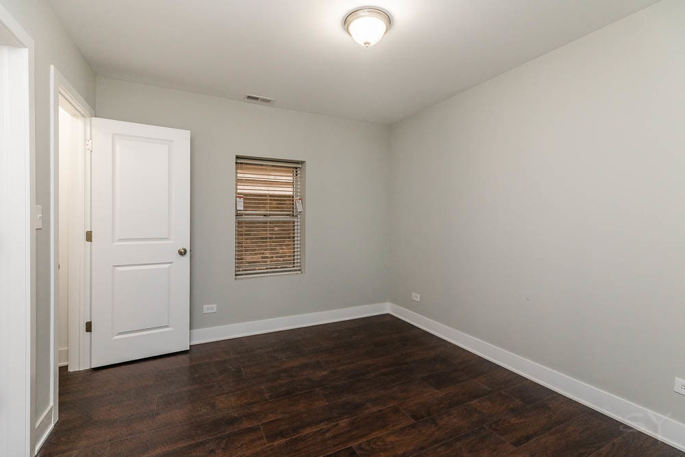 2109 West 18th Place Chicago, IL 60608 - Photo 55 of 63 a view of an empty room with wooden floor and a window