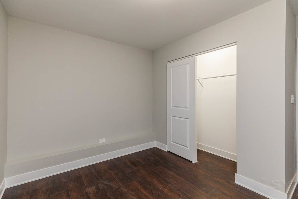 2109 West 18th Place Chicago, IL 60608 - Photo 59 of 63 a view of an empty room with wooden floor and a window