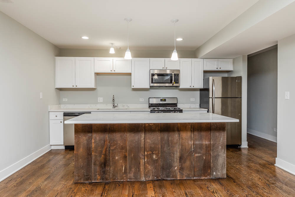 2109 West 18th Place Chicago, IL 60608 - Photo 6 of 63 a kitchen with kitchen island stainless steel appliances a sink a stove a refrigerator and cabinets