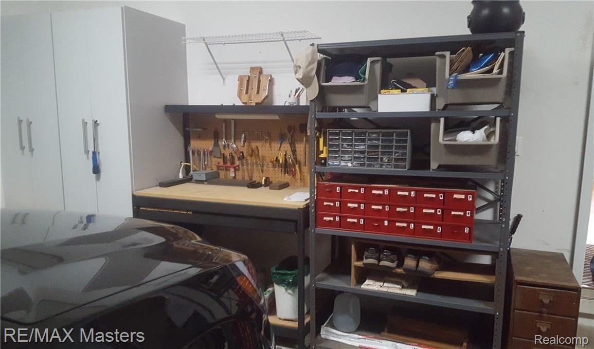4215 Brest Road Newport, MI 48166 - Photo 24 of 33 Work area in garage, shelves/racks/cabinets included.