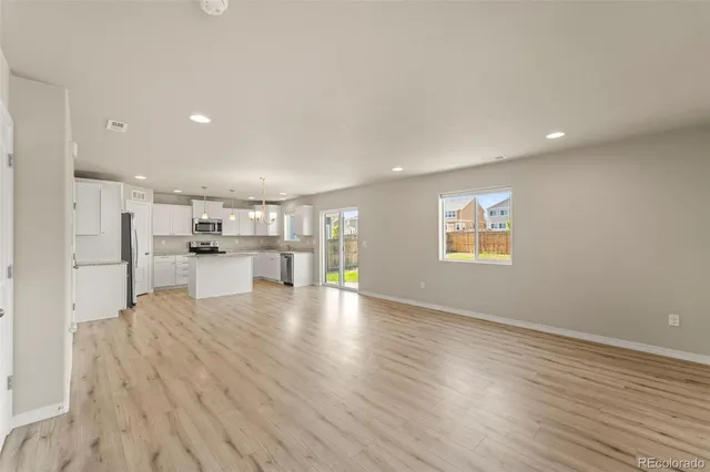 a view of kitchen with furniture and wooden floor