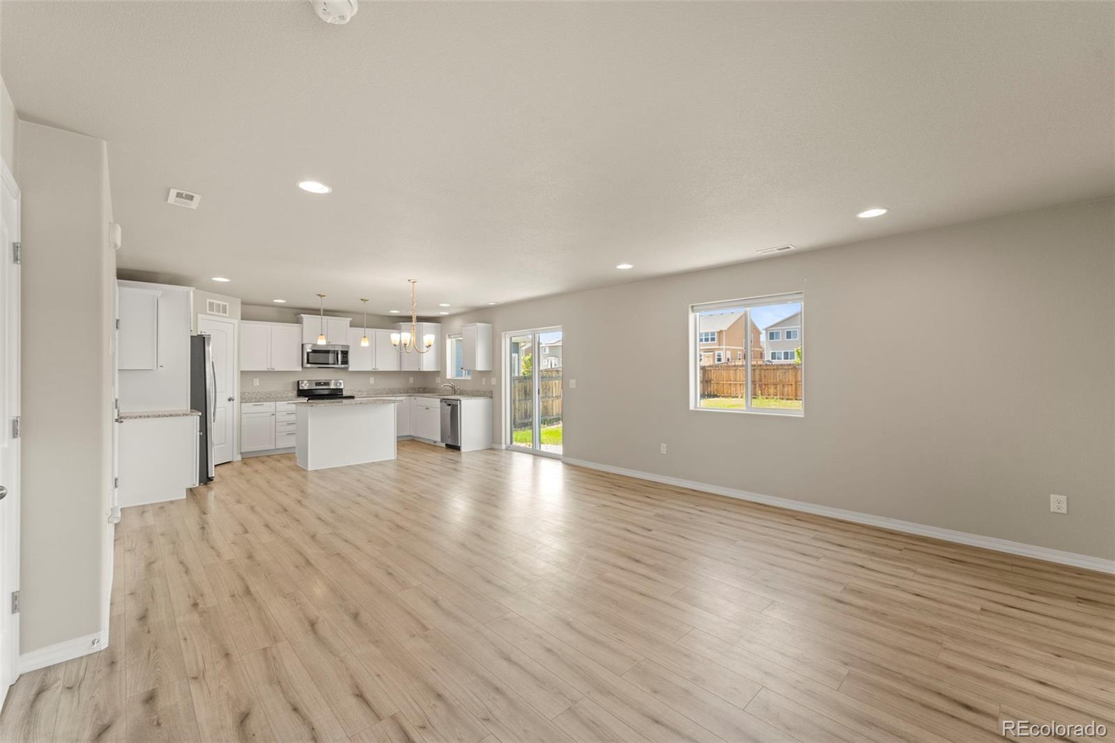 7721 Berwyn Loop Peyton, CO 80831 - Photo 14 of 35 a view of kitchen with furniture and wooden floor