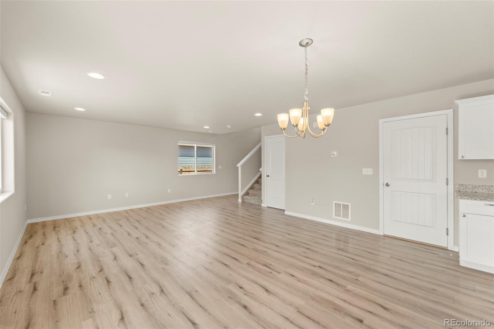7721 Berwyn Loop Peyton, CO 80831 - Photo 22 of 35 a view of an empty room with wooden floor and a window