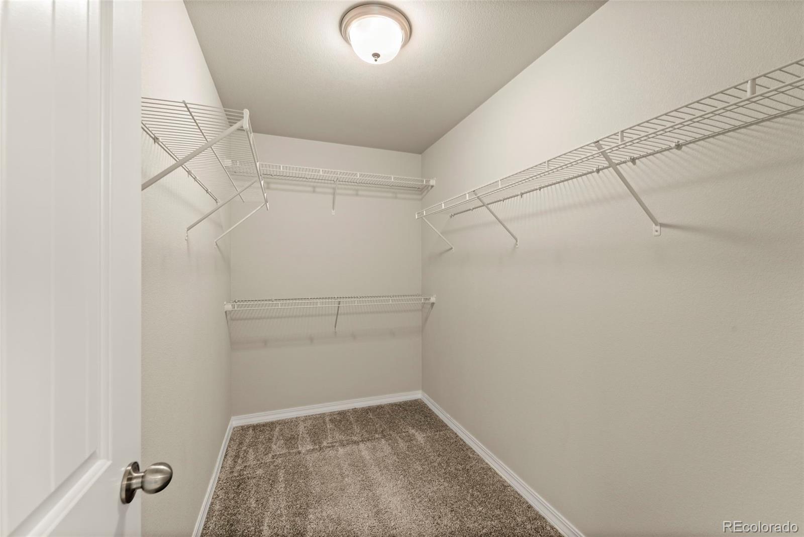 7721 Berwyn Loop Peyton, CO 80831 - Photo 29 of 35 a view of a room with racks on the wall