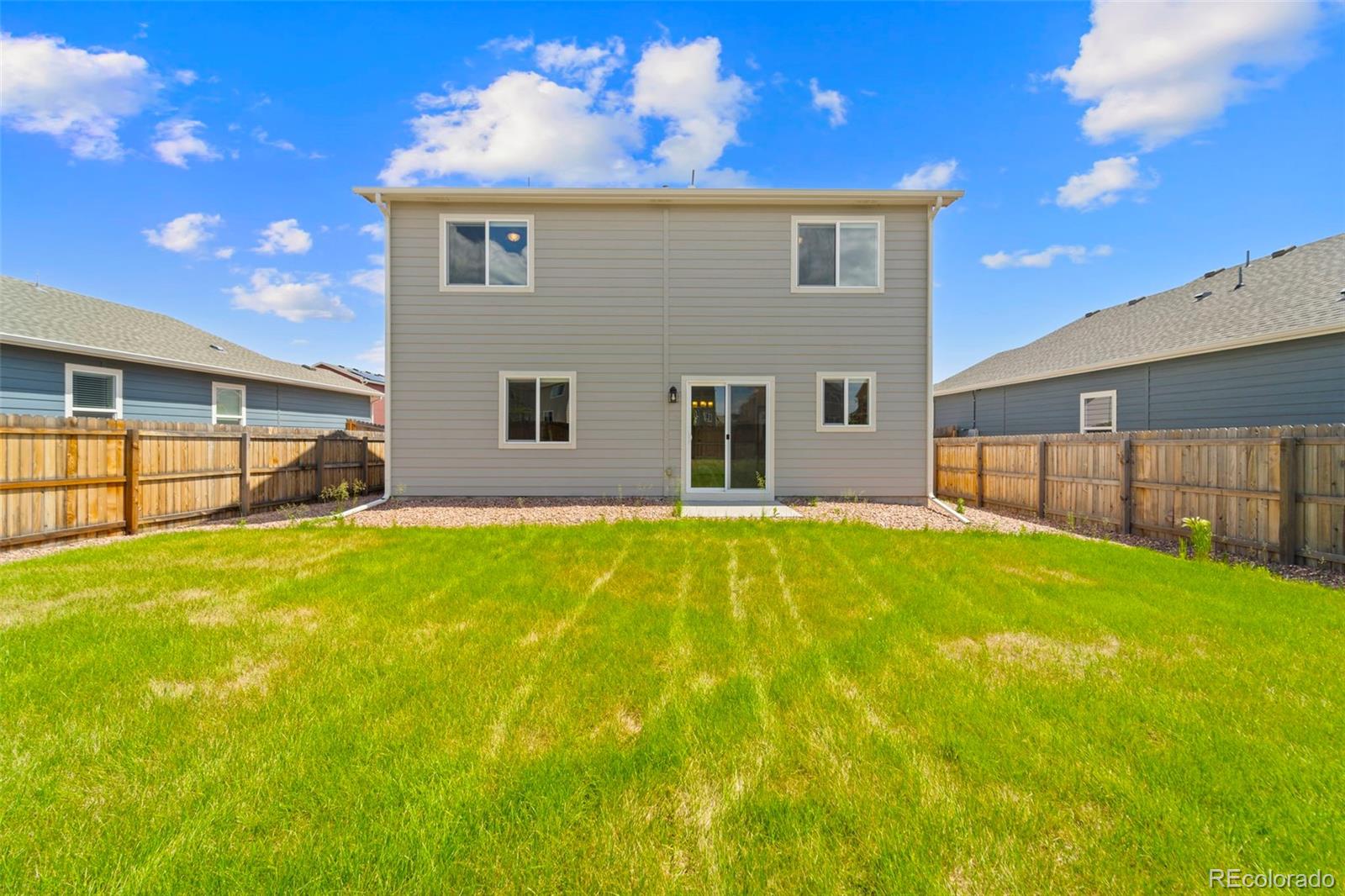 7721 Berwyn Loop Peyton, CO 80831 - Photo 34 of 35 a front view of a house with a yard