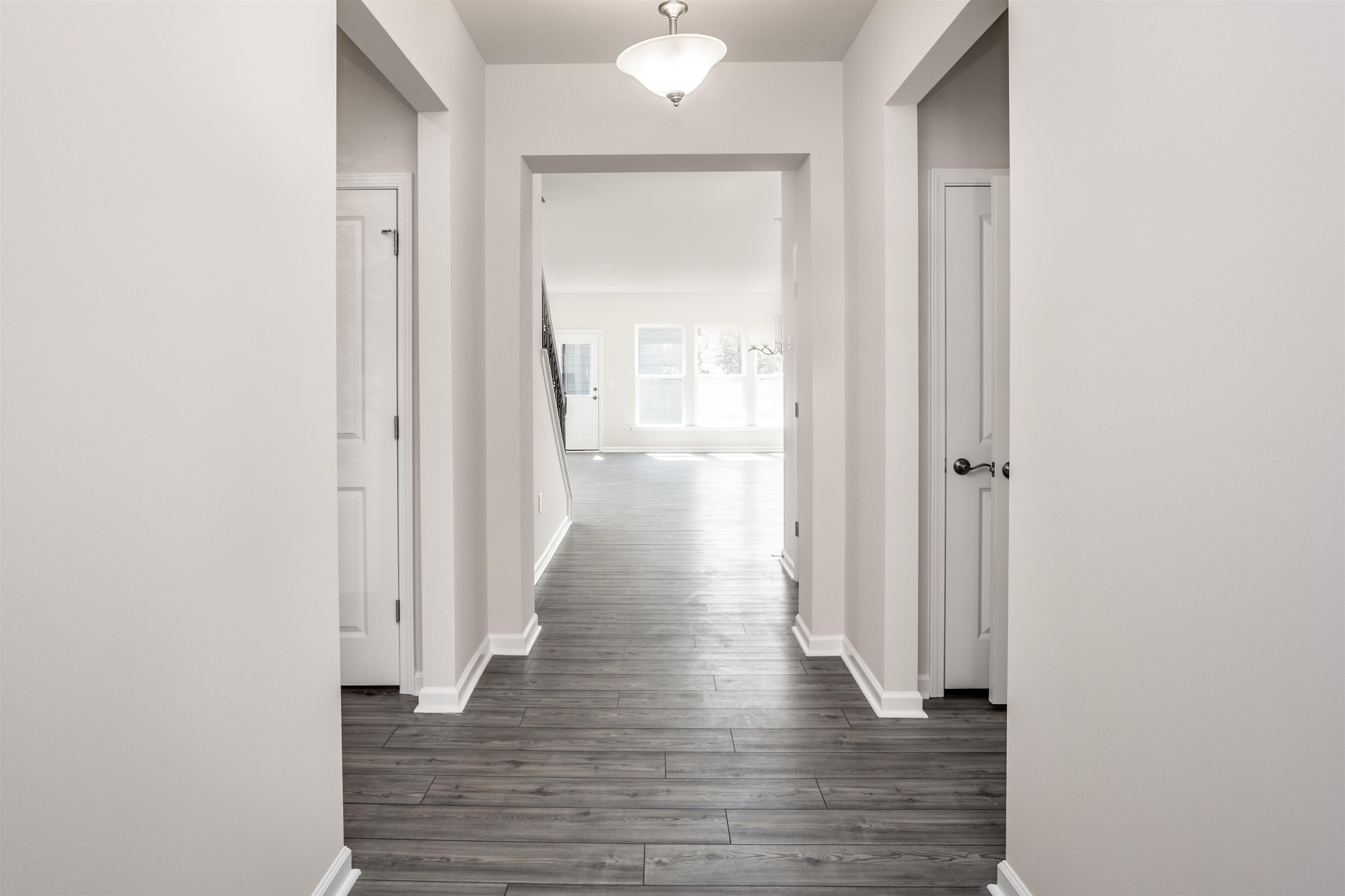 5725 Agrinio Way Raleigh, NC 27603 - Photo 3 of 27 a view of a hallway with wooden floor