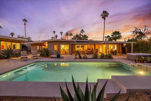 a view of a swimming pool and chairs in the patio