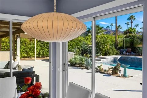 a view of a swimming pool with a patio and a garden