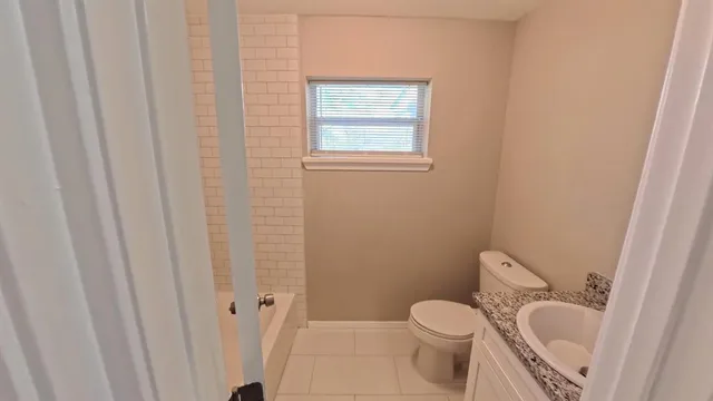 a white toilet sitting next to a small sink
