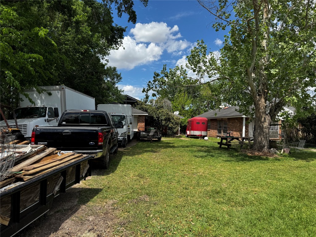 8910 Carousel Lane Houston, TX 77080 - Photo 5 of 7 a front view of a house with a yard and trees