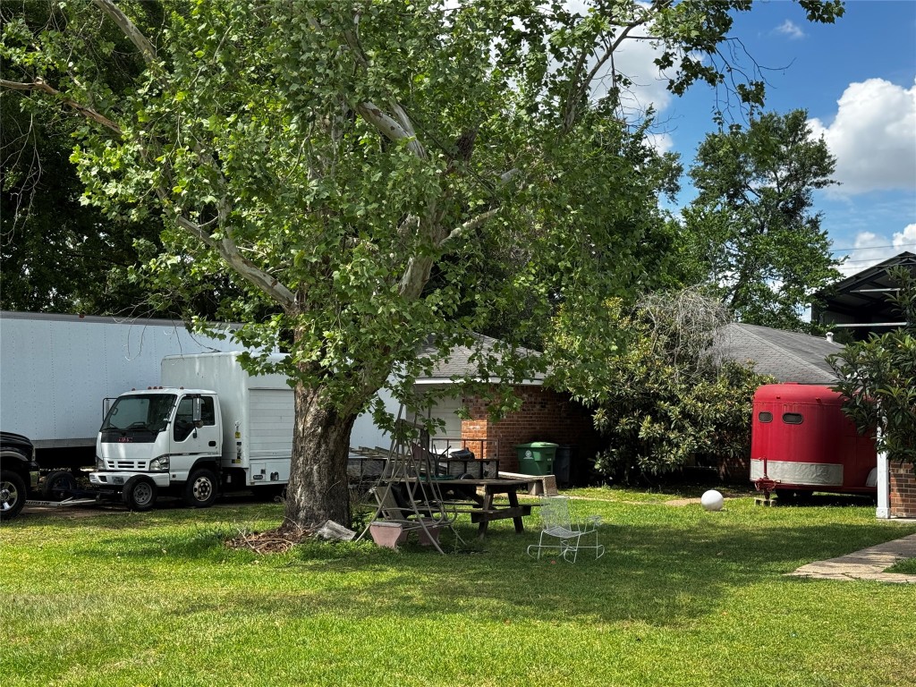 8910 Carousel Lane Houston, TX 77080 - Photo 7 of 7 a view of a house with a yard porch and sitting area