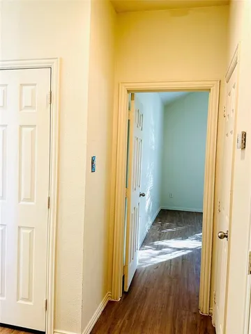 a view of a hallway with wooden floor