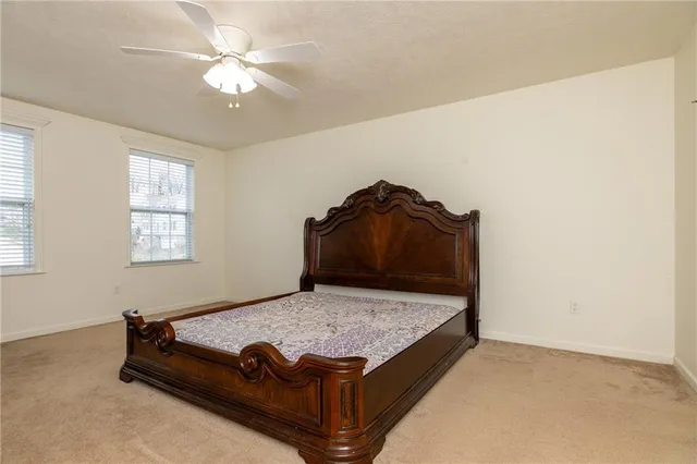 a bed sitting in a bedroom next to a window