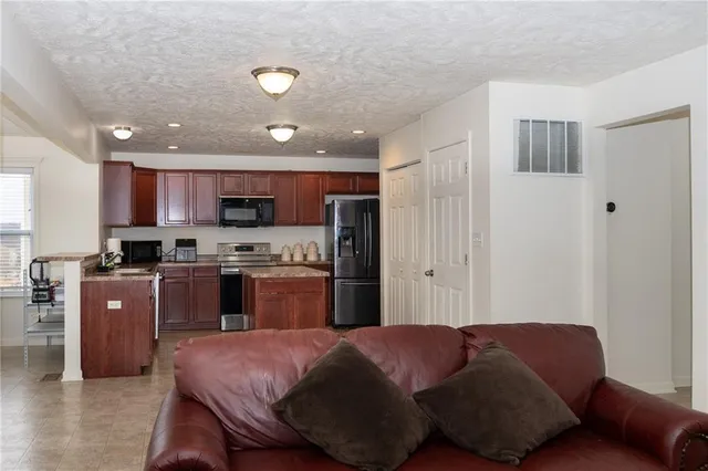 a kitchen with stainless steel appliances granite countertop a refrigerator sink and cabinets