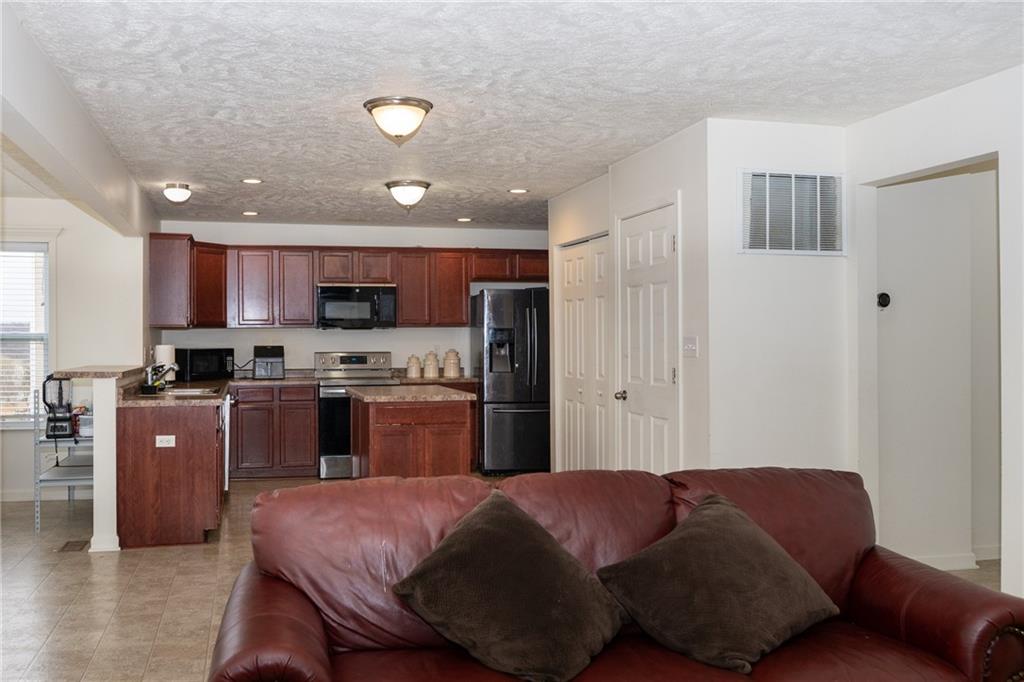 100 Willow Drive Natrona Heights, PA 15065 - Photo 6 of 20 a kitchen with stainless steel appliances granite countertop a refrigerator sink and cabinets