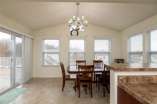a view of a dining room with furniture and a chandelier