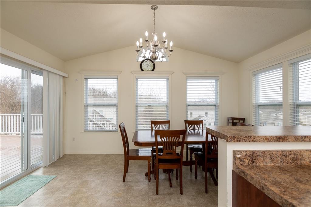 100 Willow Drive Natrona Heights, PA 15065 - Photo 10 of 20 a view of a dining room with furniture and a chandelier