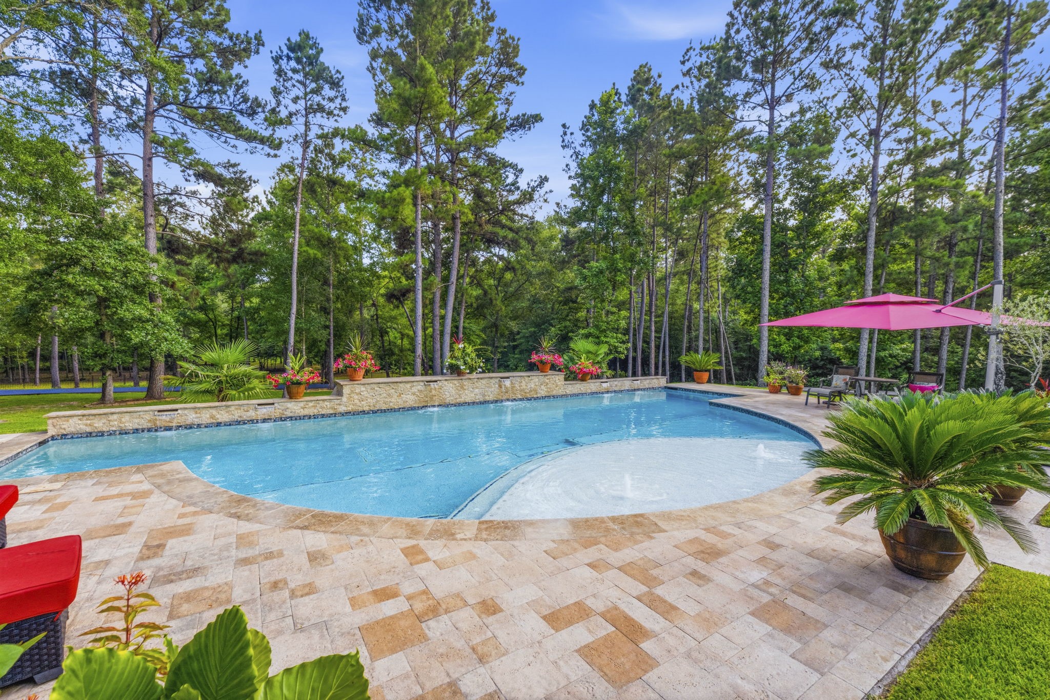 280 Sundog Road Huntsville, TX 77340 - Photo 44 of 50 Beautiful view of the pool creates a perfect setting for relaxing outdoors and enjoying peaceful moments surrounded by trees.