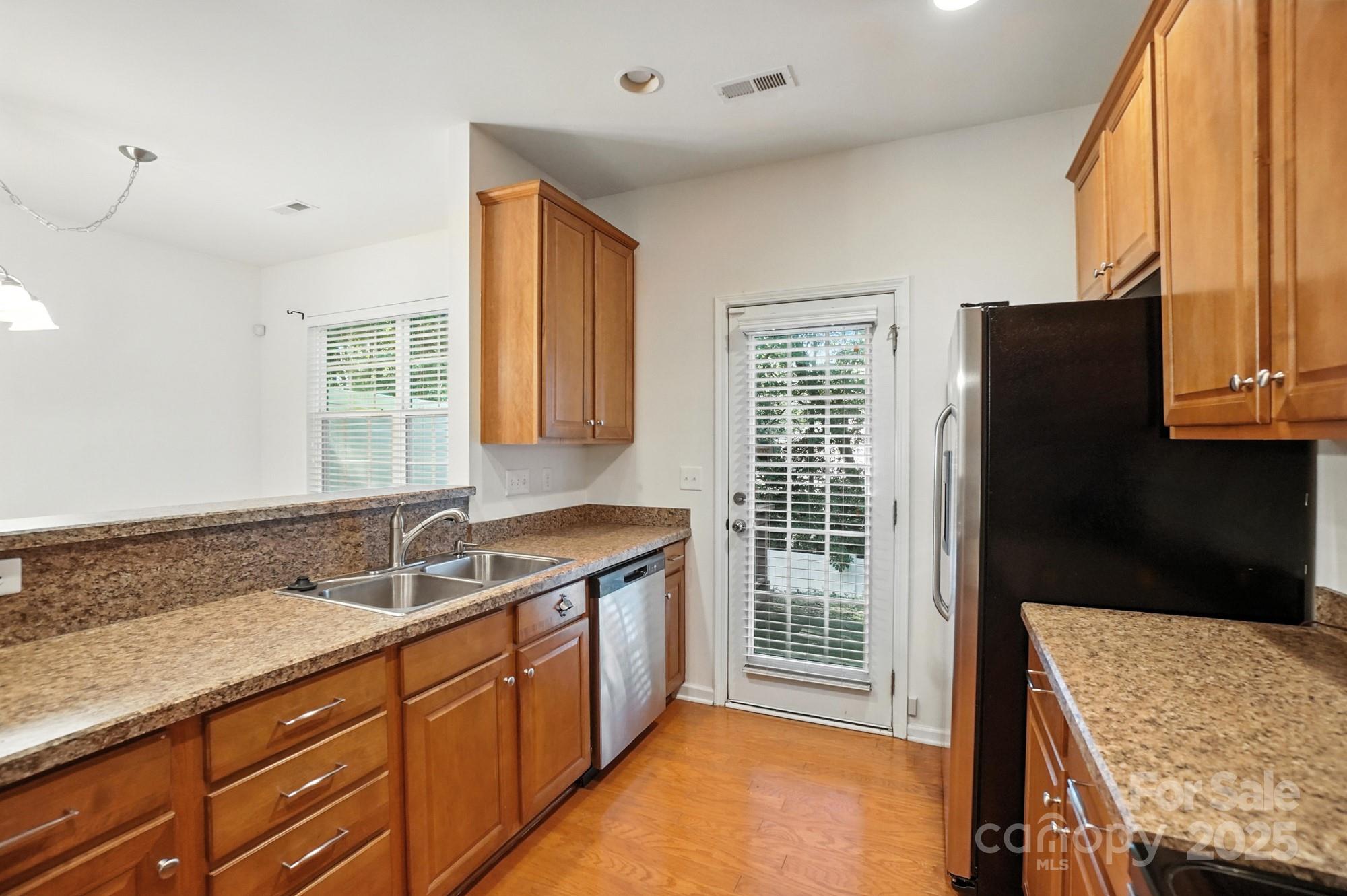 13116 Erwin Road Charlotte, NC 28273 - Photo 11 of 27 a bathroom with a granite countertop sink a mirror and a shower