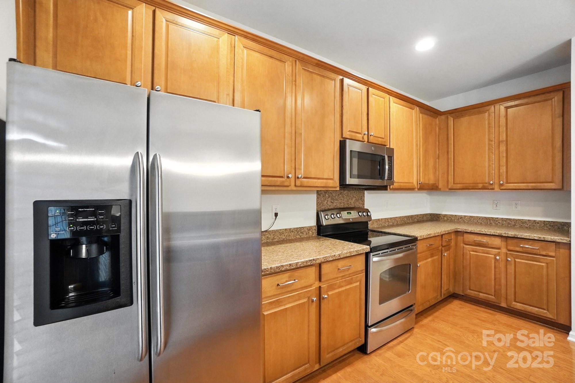 13116 Erwin Road Charlotte, NC 28273 - Photo 12 of 27 a kitchen with a refrigerator microwave and sink