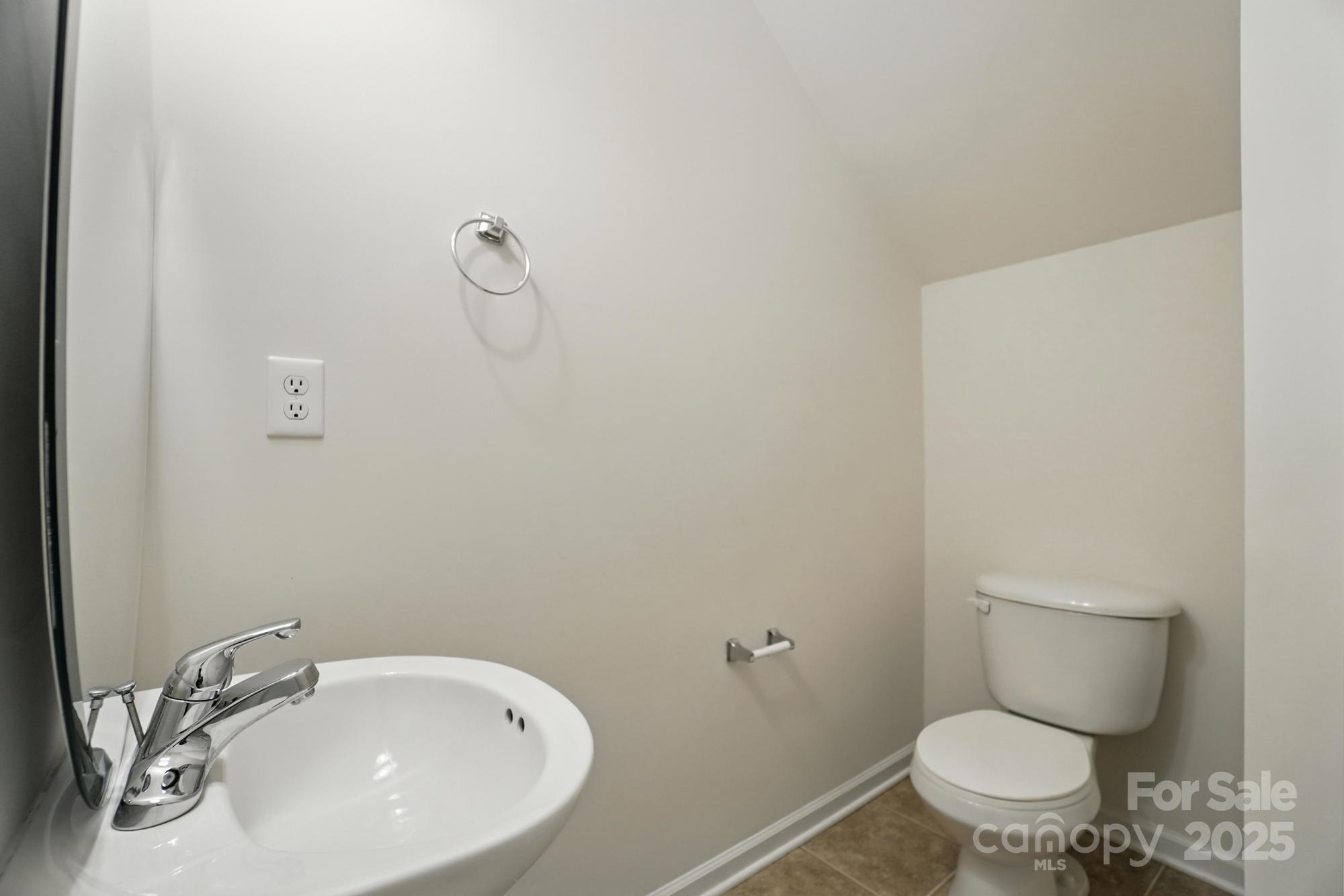13116 Erwin Road Charlotte, NC 28273 - Photo 13 of 27 a white toilet sitting next to a bathroom sink