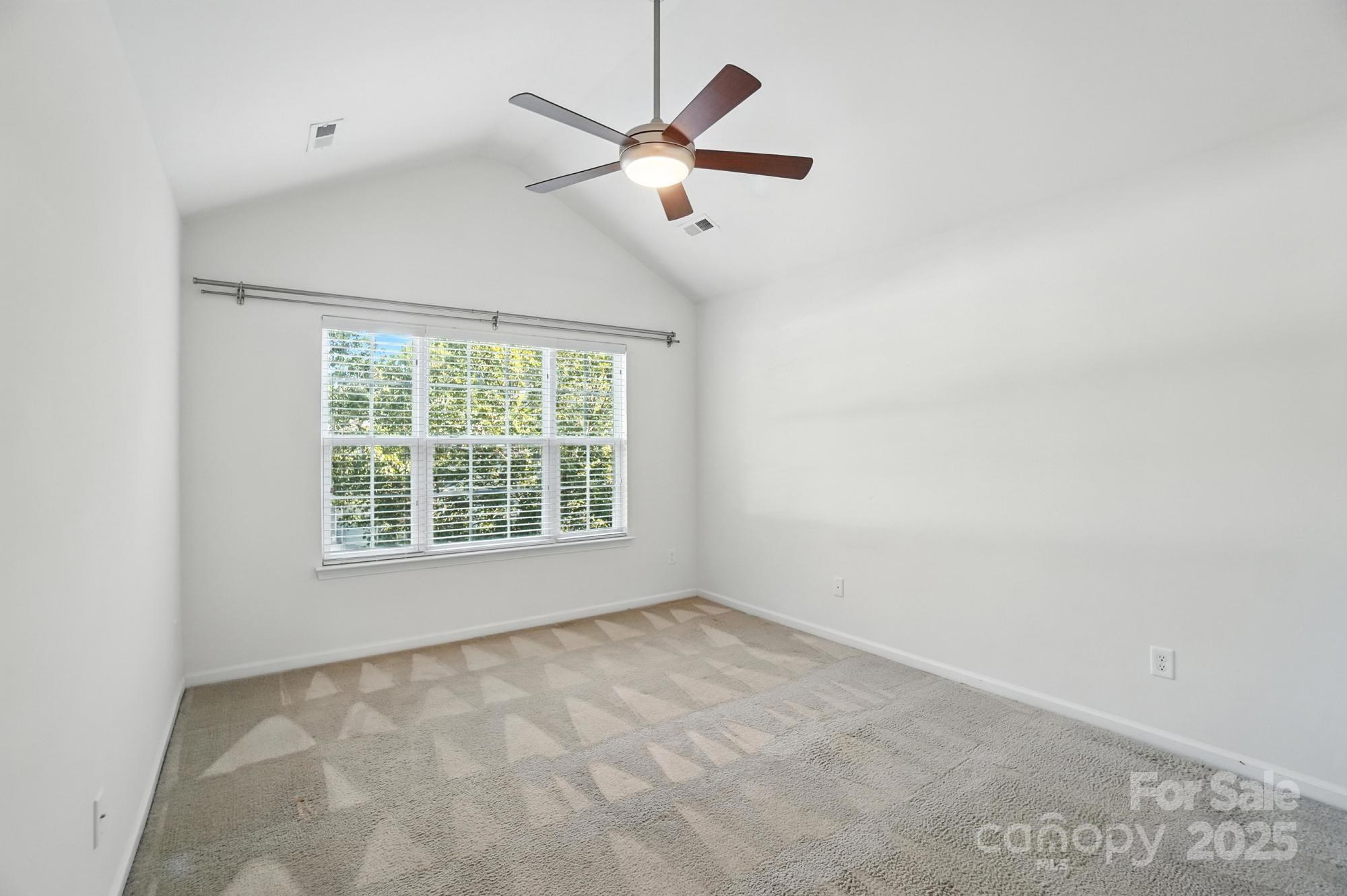 13116 Erwin Road Charlotte, NC 28273 - Photo 16 of 27 an empty room with ceiling fan and window