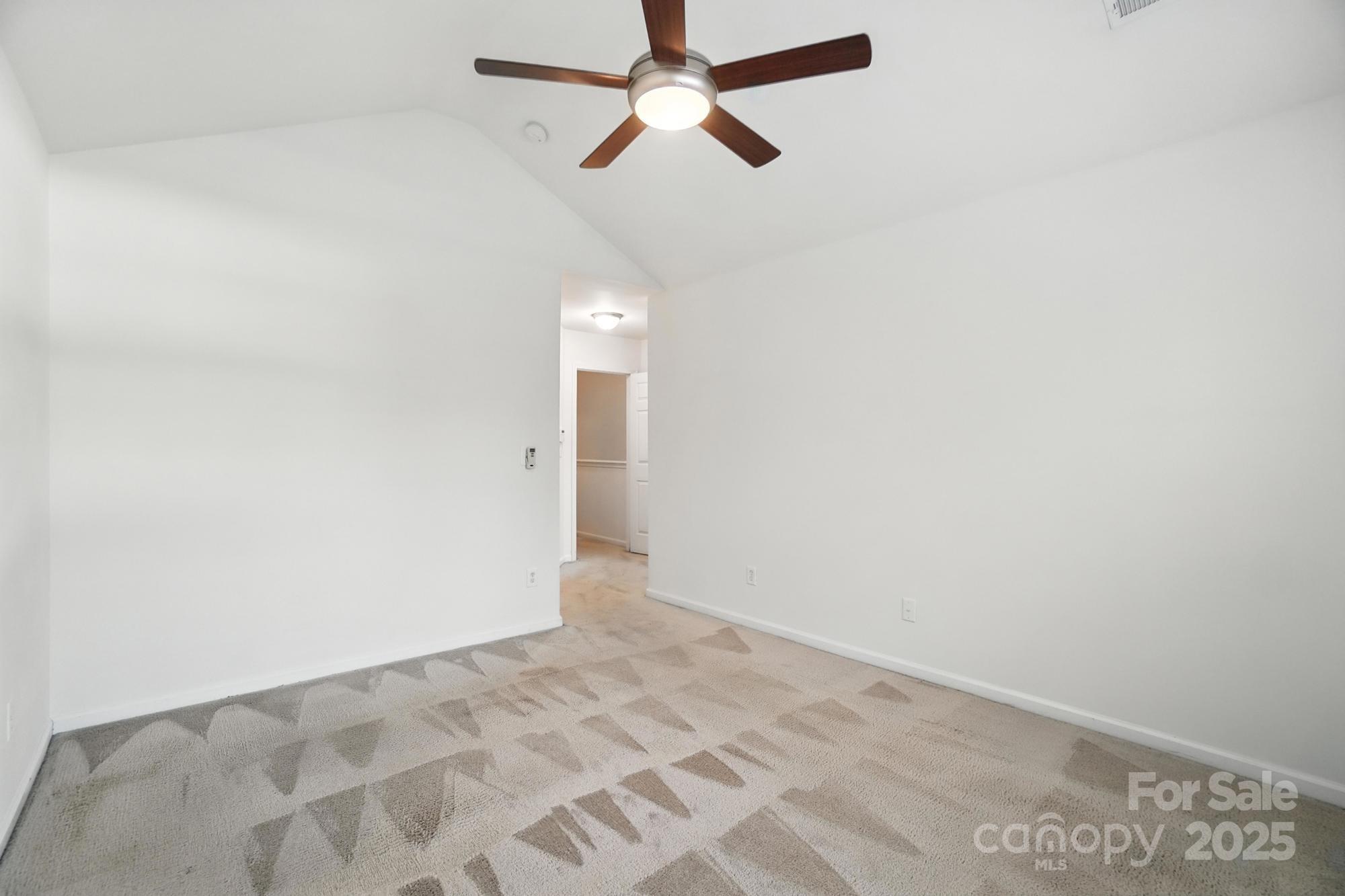 13116 Erwin Road Charlotte, NC 28273 - Photo 17 of 27 a view of a room with a ceiling fan and carpet