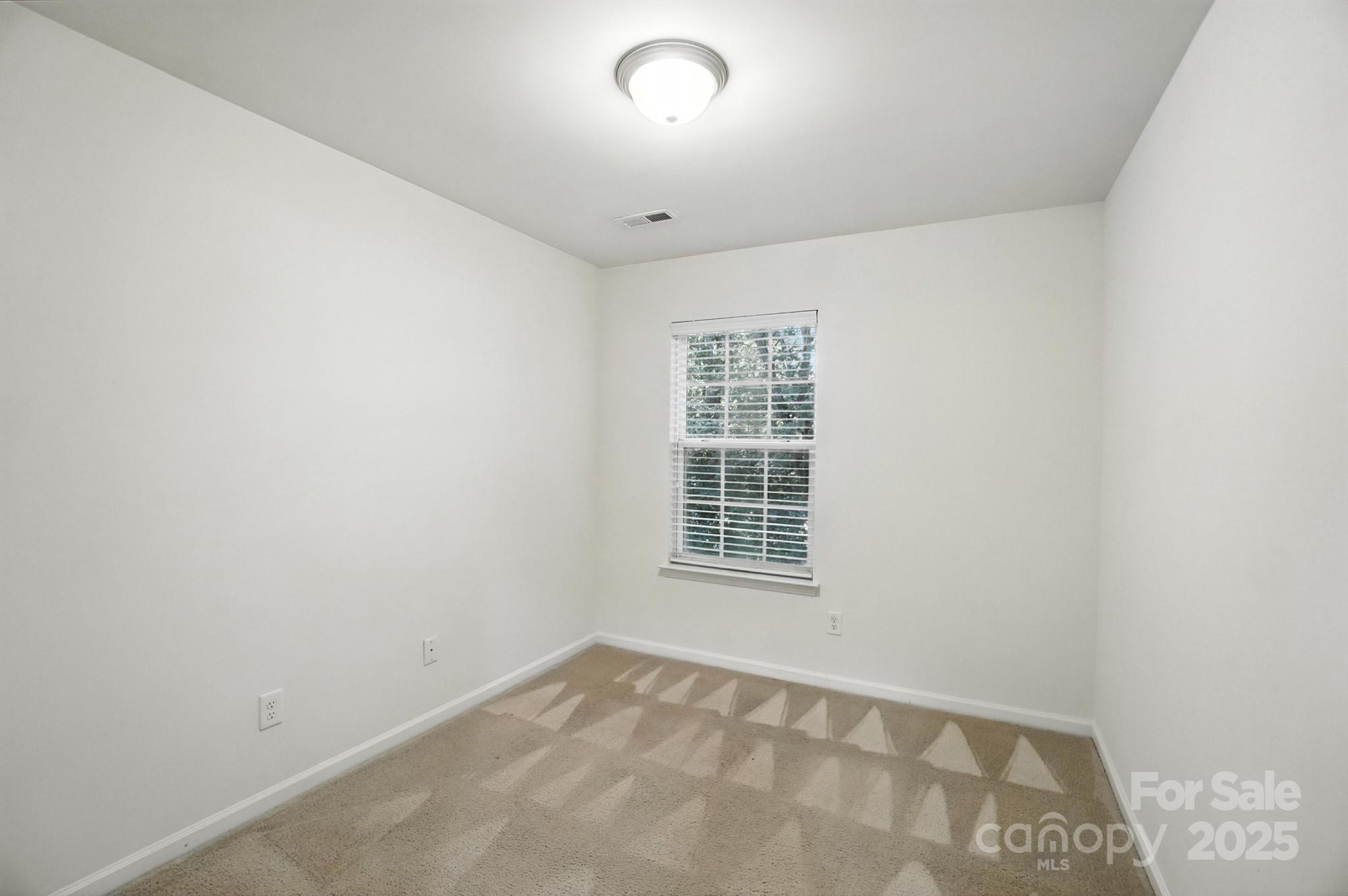 13116 Erwin Road Charlotte, NC 28273 - Photo 25 of 27 an empty room with windows
