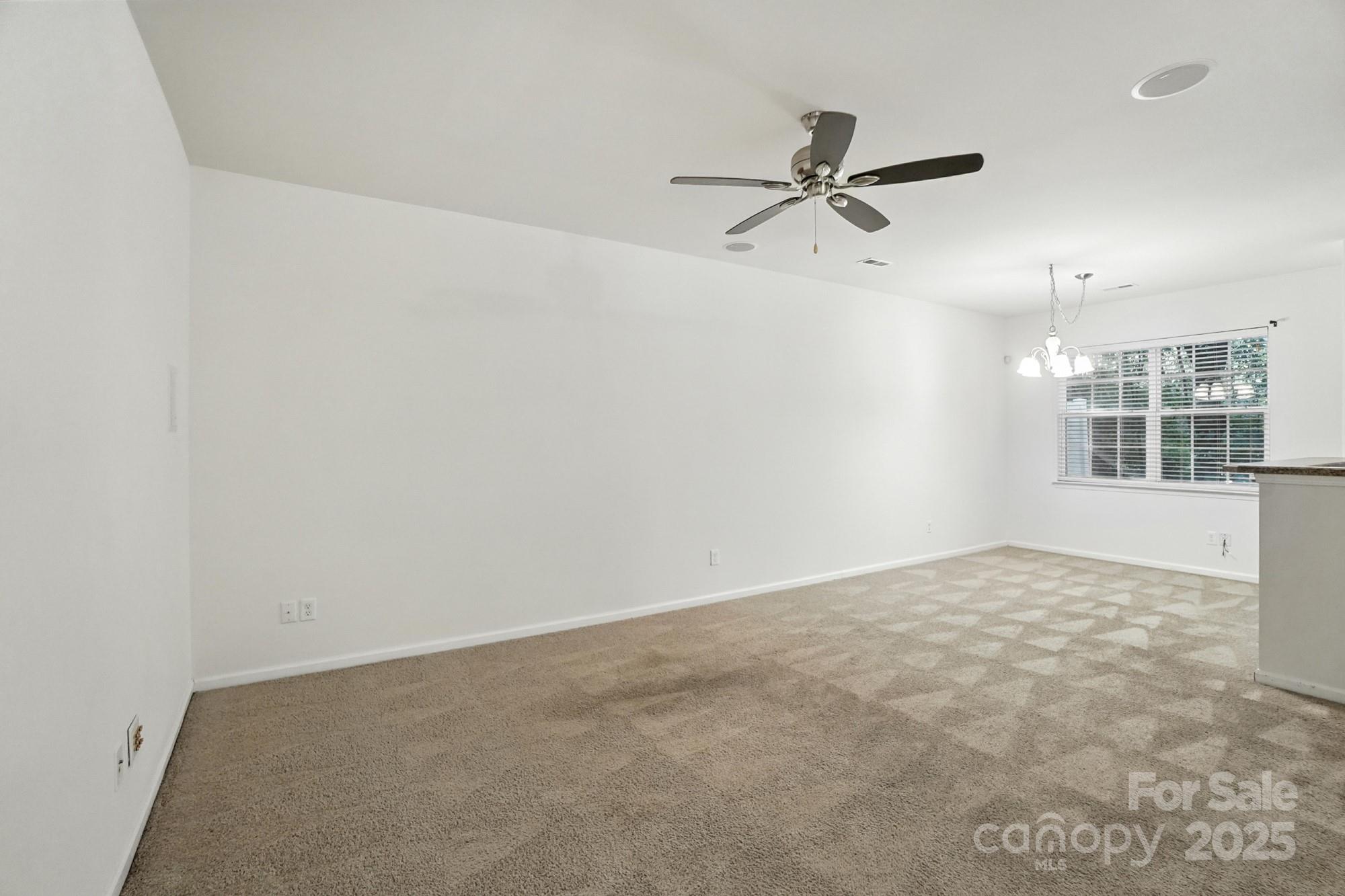 13116 Erwin Road Charlotte, NC 28273 - Photo 5 of 27 an empty room with windows and fan
