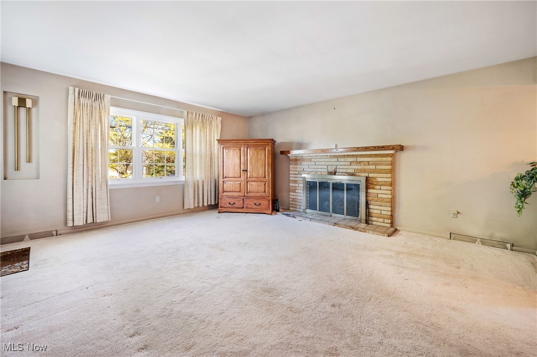 844 Roseland Road Alliance, OH 44601 - Photo 15 of 40 Unfurnished living room with carpet and a fireplace