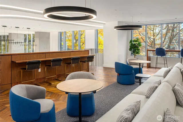 a living room with furniture a lamp and a large window