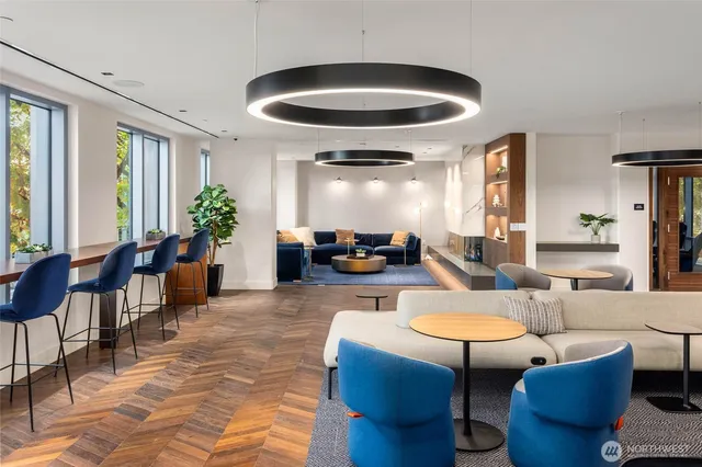 a living room with furniture potted plant and a chandelier