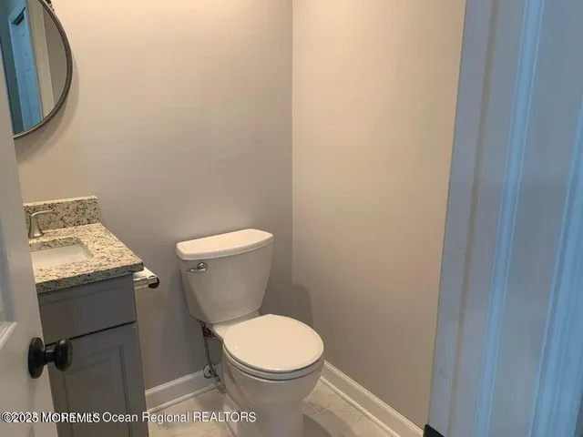 a white toilet sitting next to a bathroom sink