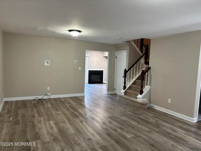 wooden floor in an empty room with a fireplace