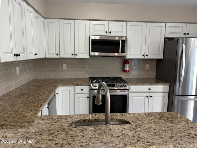 a kitchen with a stove and a refrigerator