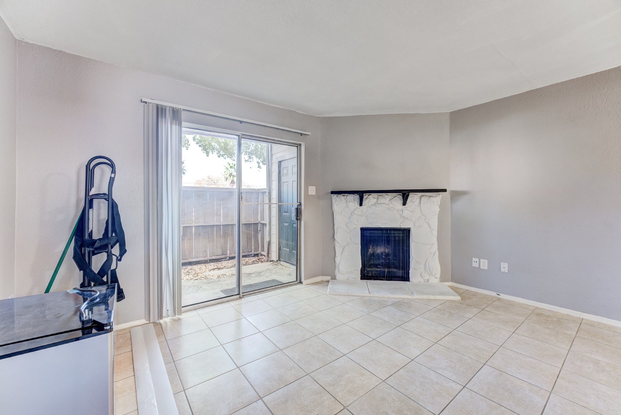 6001 Reims Road, Unit 1101 Houston, TX 77036 - Photo 12 of 35 a view of an empty room with a fireplace and a window