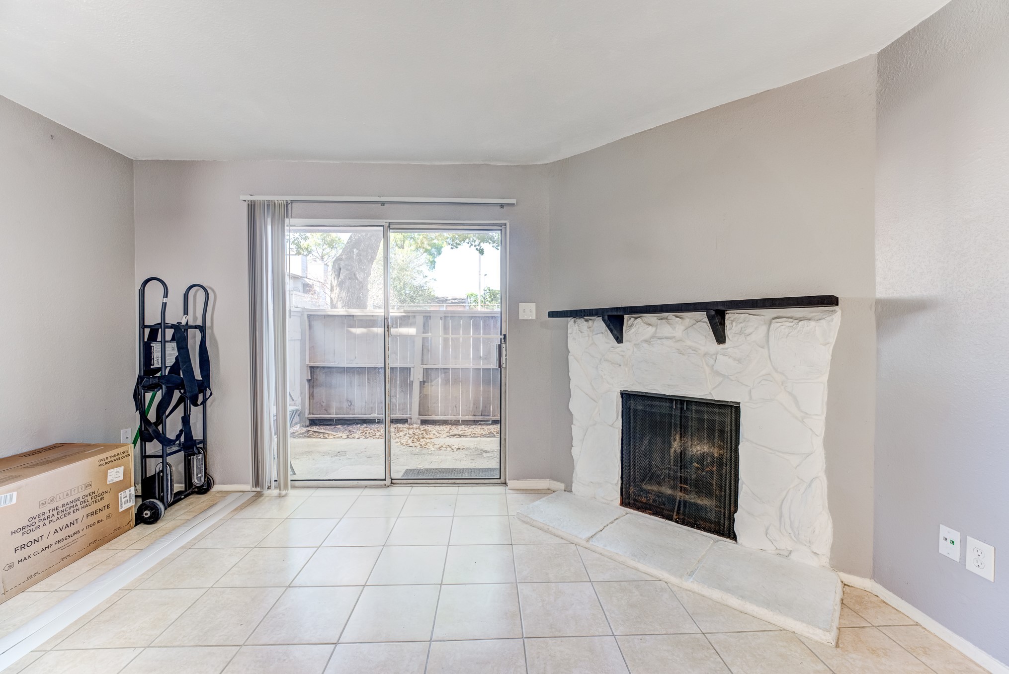 6001 Reims Road, Unit 1101 Houston, TX 77036 - Photo 13 of 35 an empty room with fireplace and windows