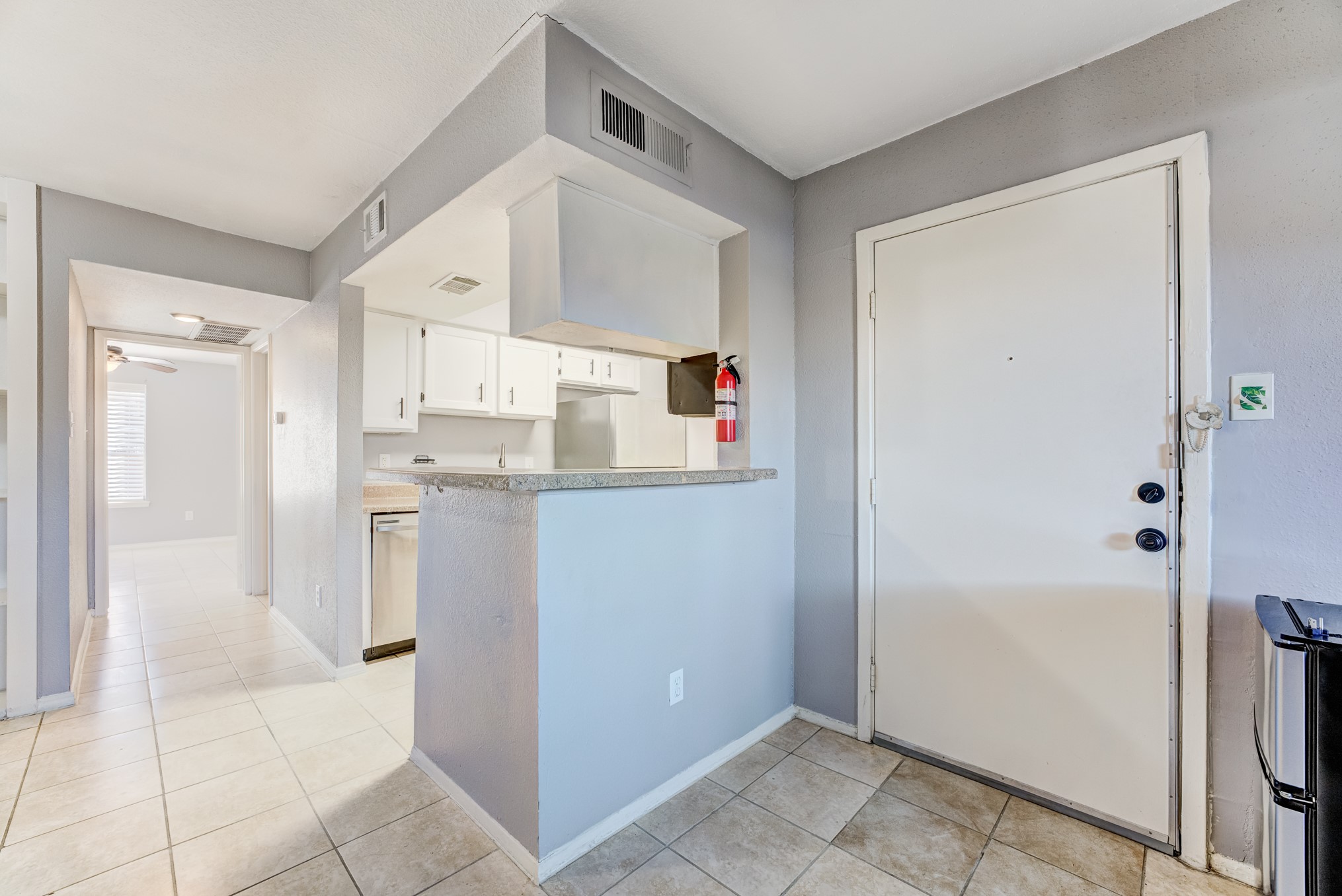 6001 Reims Road, Unit 1101 Houston, TX 77036 - Photo 16 of 35 a kitchen with white cabinets and refrigerator