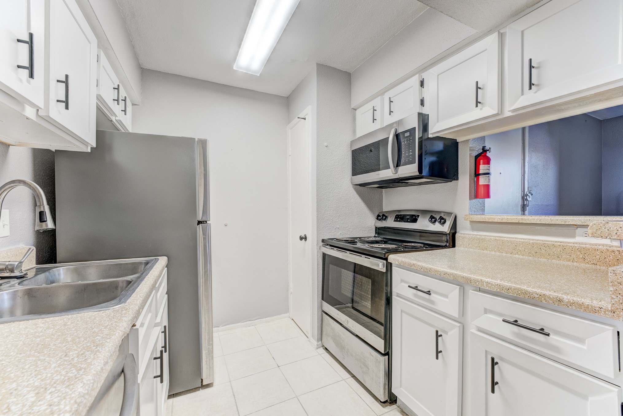 6001 Reims Road, Unit 1101 Houston, TX 77036 - Photo 23 of 35 a kitchen with stainless steel appliances granite countertop a sink stove and cabinets
