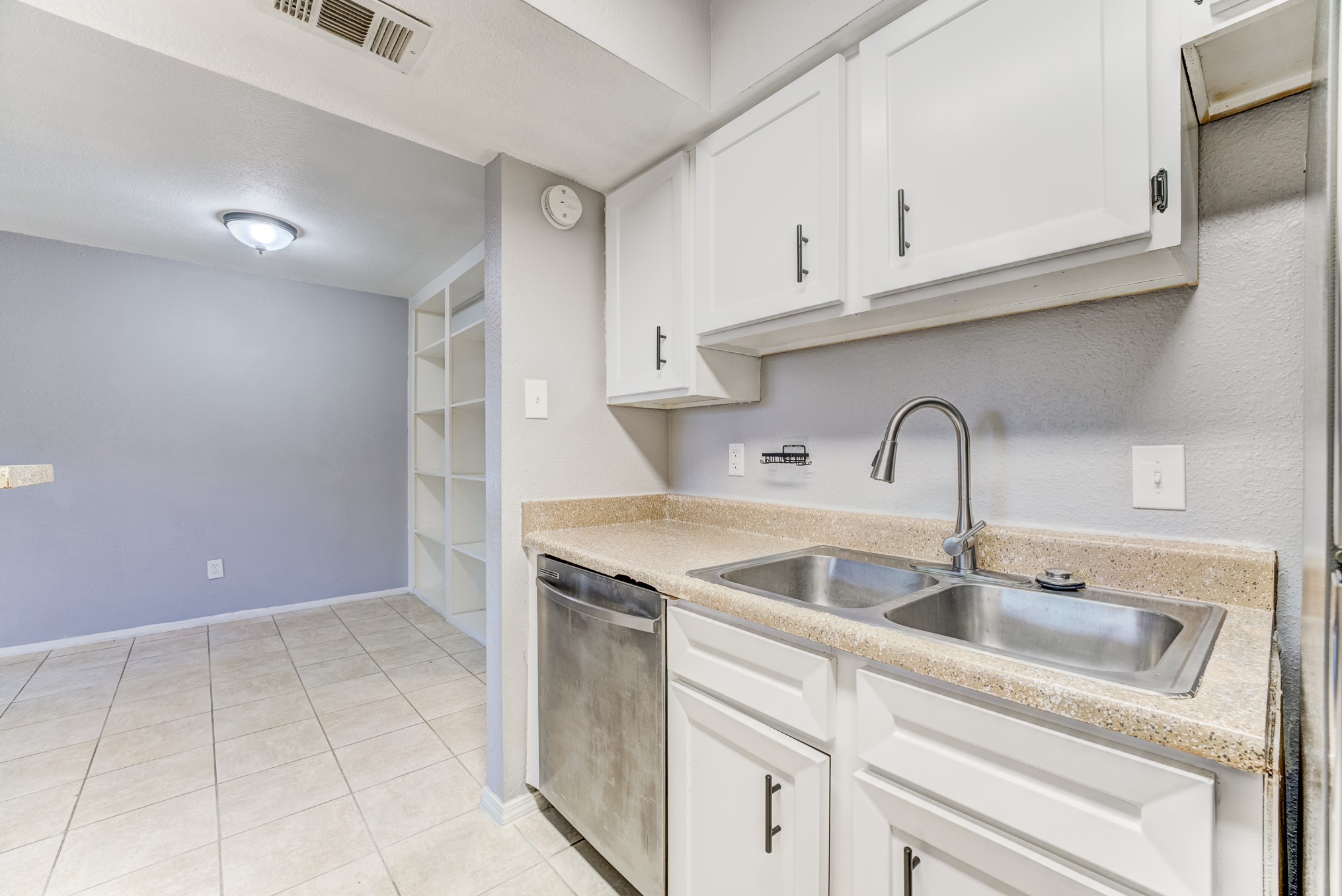 6001 Reims Road, Unit 1101 Houston, TX 77036 - Photo 24 of 35 a kitchen with a sink and cabinets